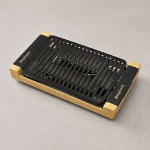 smokeless grill with matte black rectangular ridged plate in a natural wood base by MagiCook