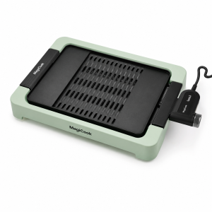 MagiCook smokeless grill with black interchangeable plate and pale green nylon base for indoor tabletop cooking